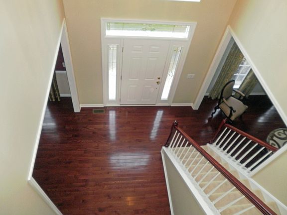 Two story hardwood entrance foyer