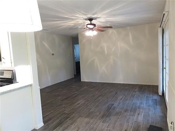 View from dining into living area. Flooring is wood-look cer