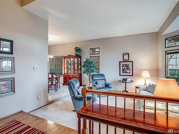 This immaculate home boasts a bright entry with hardwood floors and open sight lines into the living room and dining room. A large bay window keeps this space light and bright in all seasons. 