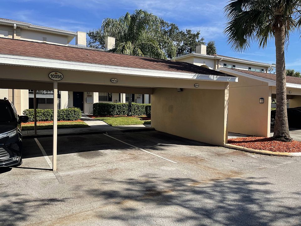 One covered Private Parking spot next to wall.