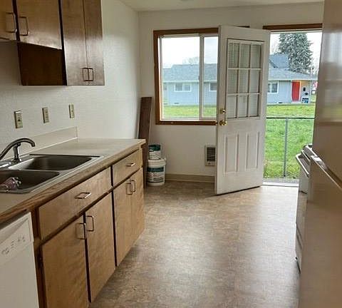 looking through the kitchen from the hallway. Dining area under window.