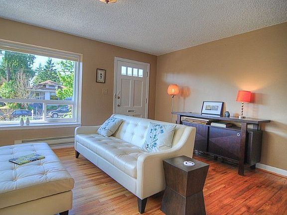 Living Room is light & bright and features refinished hardwoods & double-paned windows