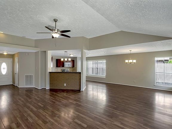 A view from the master bedroom thru the living room into the kitchen. Recent paint and light fixtures and all new blinds in the entire home.