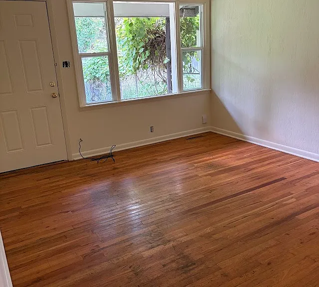 Living room opens to garden. Freshly painted ceiling, walls and trim. Beautiful original hardwood floors in great condition. New ceiling fan/LED light fixture now installed.