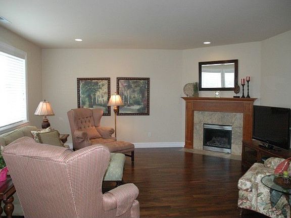 Adjacent to the kitchen is a large family room with a cozy gas fireplace. The fireplace is trimmed o
