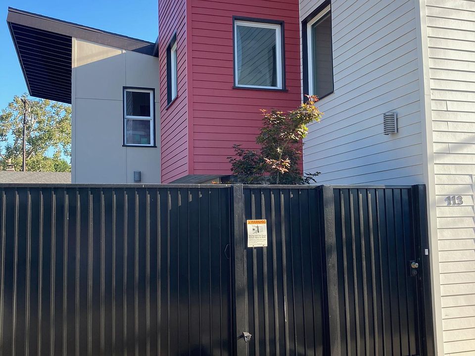 Front entrance showing secure walk-in gate and rolling car gate with remote.