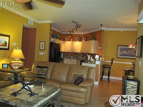 View of Kitchen area with Custom cabinets, Granite counter tops, and upgraded black appliances.