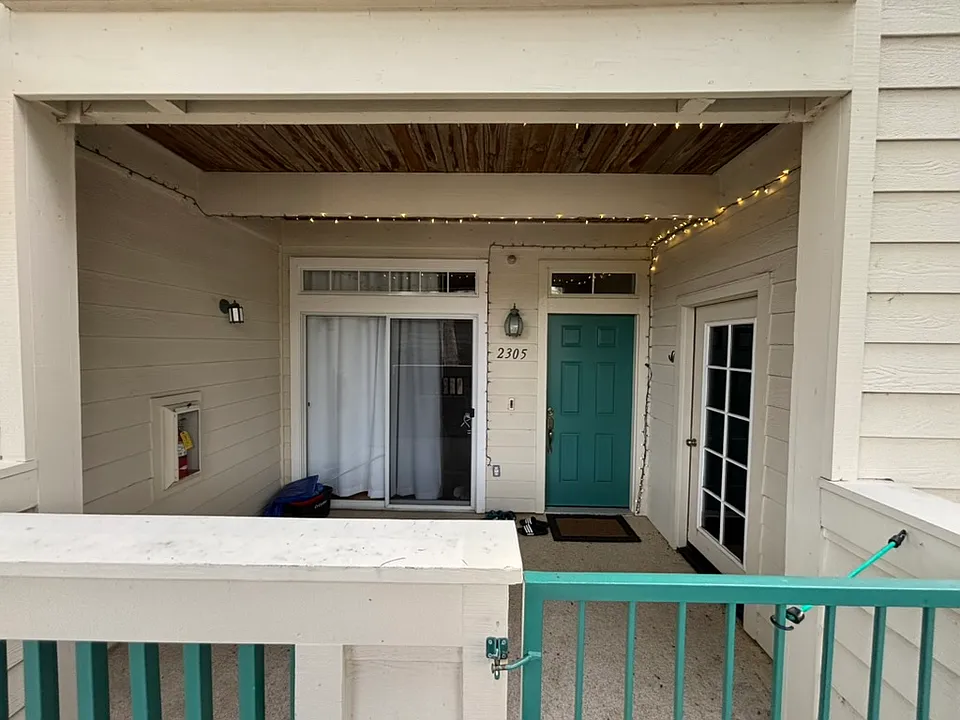Unit entrance. Epoxy patio surface.