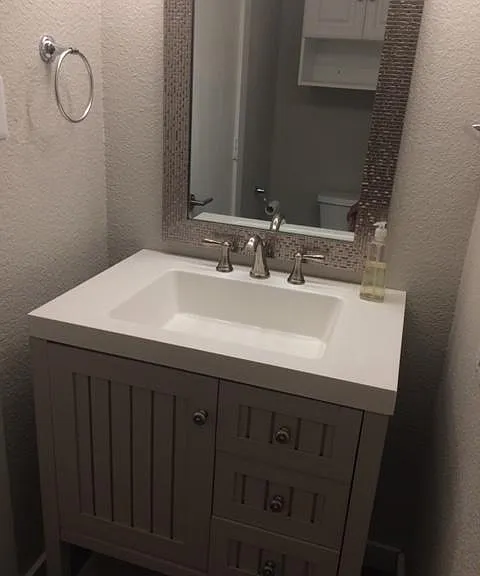 1/2 bath on lower level located between kitchen and living room is perfect for guests!