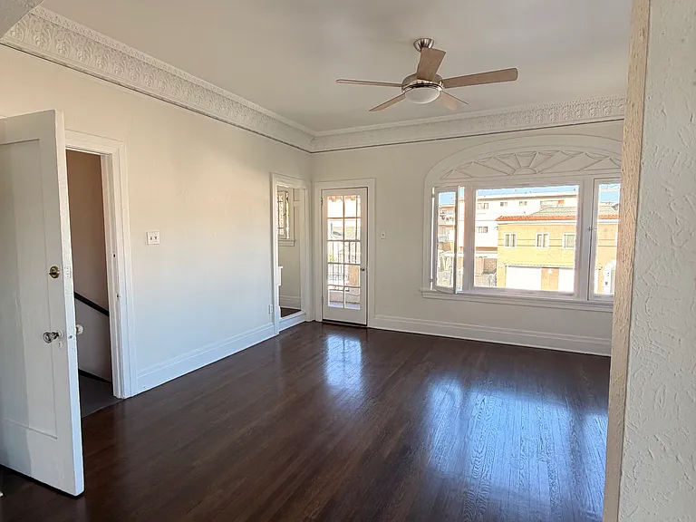 another view of the living room showing the stairs down from the front entrance