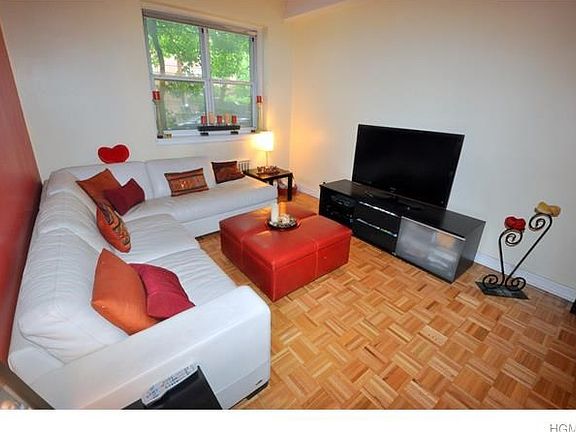 Large living room has 9'- 6" beamed ceilings, refinished parquet floors and is large enough for both a living area and dining area.