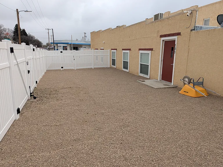 Private fenced yard with dual gate driveway access