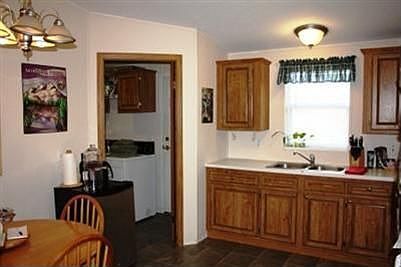 Kitchen eating area with pantry and laundry to the left, access to back door.