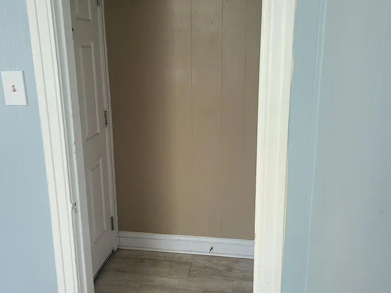 Living room into foyer and front door on the left.
