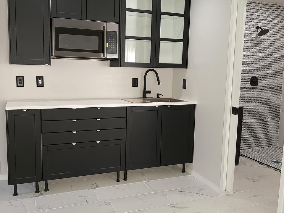 Bath room is a full stand up shower. vanity includes a sensor faucet. Bathroom also includes a sensor fan which turns on and off depending on the humidity in the room.