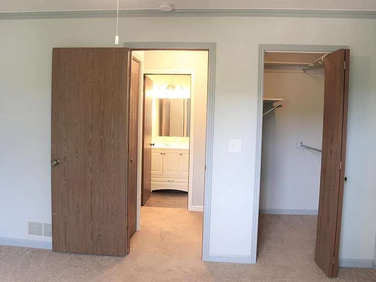 From primary bed- hall with adjacent bath and walk-in closet in bedroom.