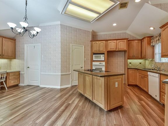 Large kitchen has lots of elbow room, granite counter tops and laminate flooring.