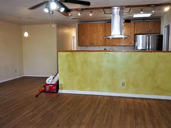 Open plan with family room, dining area and kitchen (laundry room adjacent to kitchen). The entire interior will be freshly painted.