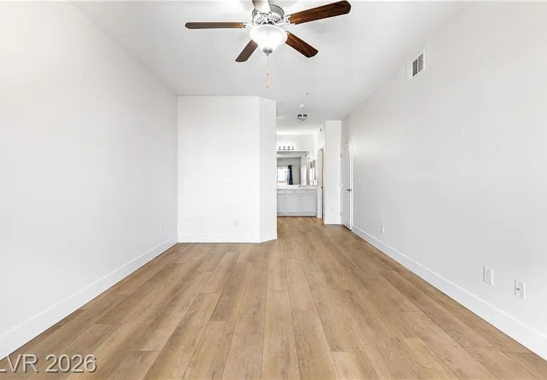 Primary bedroom with ceiling fan & light
