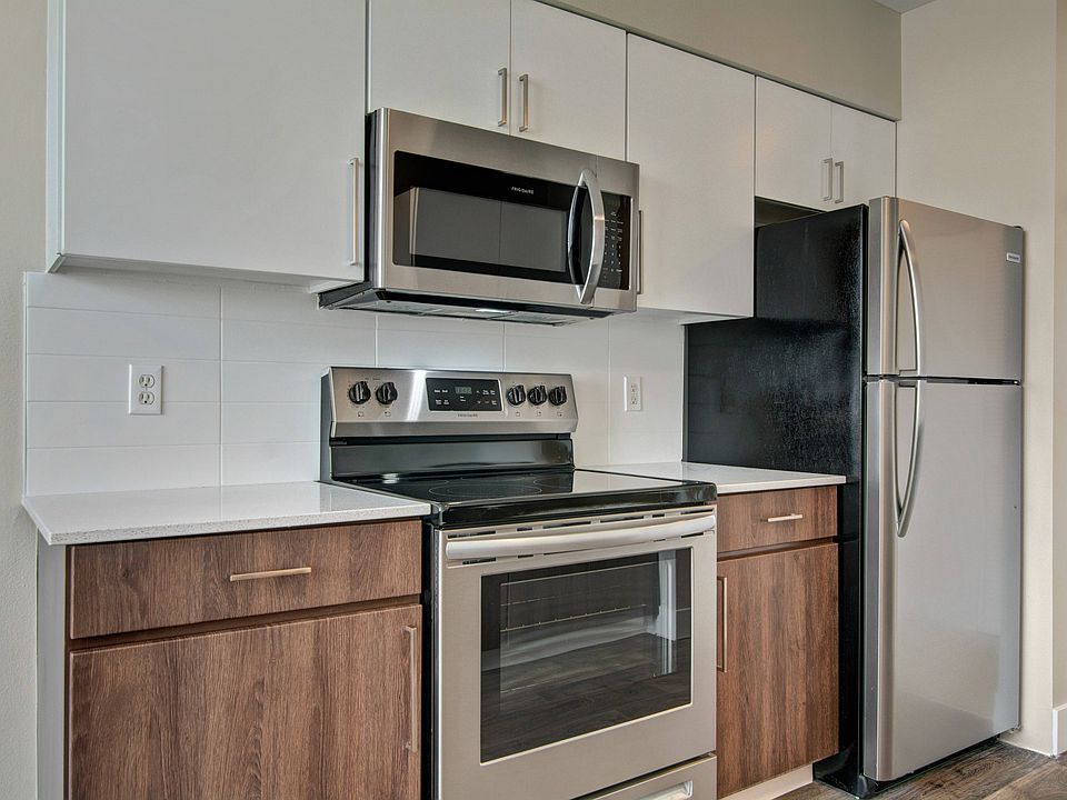 Elegant Kitchen Finishes with Subway Tile Backsplash and Quartz Courtertops