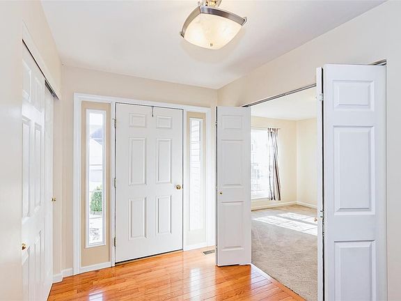 Entry foyer is so welcoming with gleaming wood floors