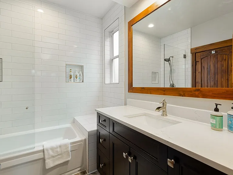Guest Bathroom with Shower, Tub, and Quartz Countertops