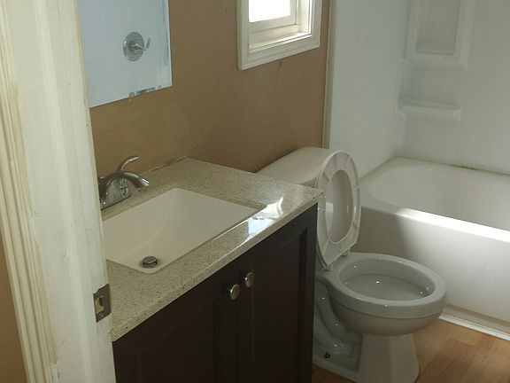 Guest Bathroom, newer toilet, vanity, and floors