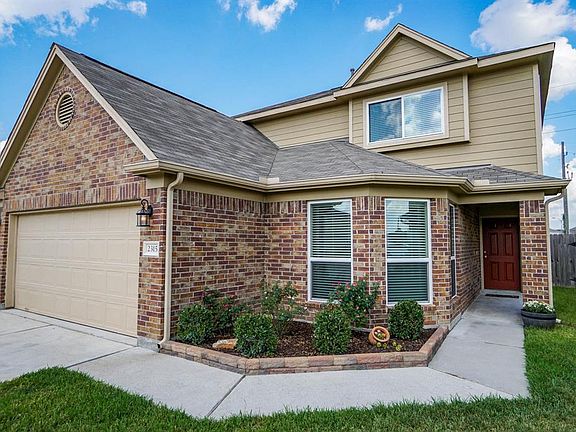 Beautiful landscaping is highlighted by upgraded exterior coach lighting