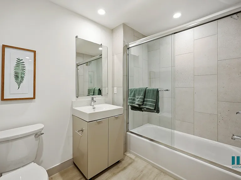 Bathroom with Shower Bath with a Glass Door and Vanity Cabinet Storage