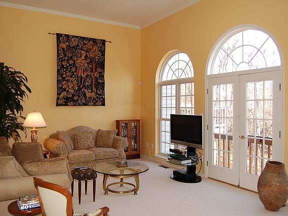 Dramatic sunken Living room with 13 ft. ceiling and Palladian windows