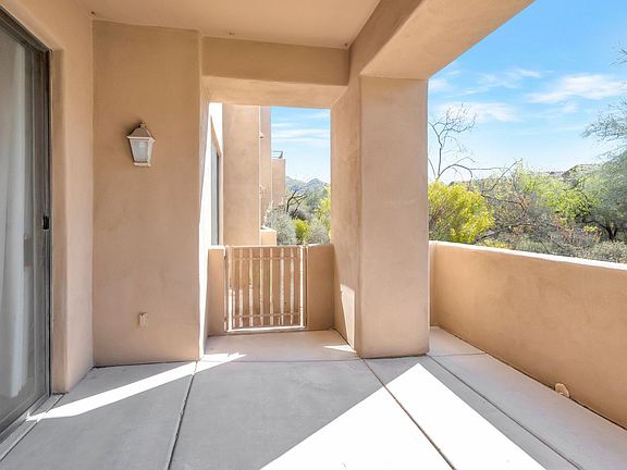 Patio off the family room with a gate out to the center path.