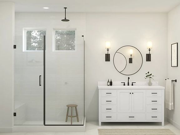 Primary bath with glass shower enclosure and matte black fixtures