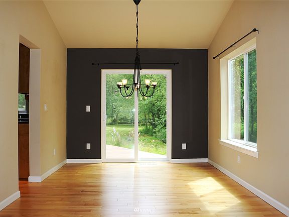 Looking from living room back to the dining area and one of the sliding glass doors to the massive back deck. >