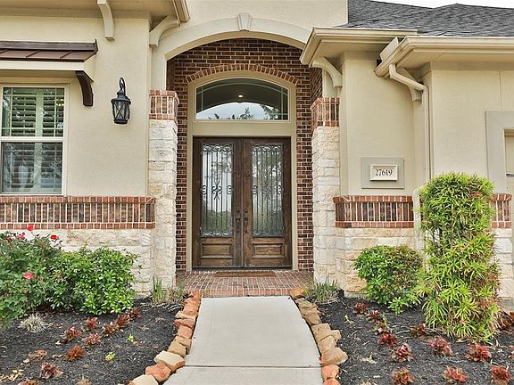 The lead and glass double doors set the tone for this impressive home