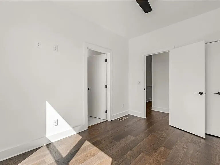 Guest Bedroom (Note: Actual unit has light wooden floors and upgraded fixtures / appliances)