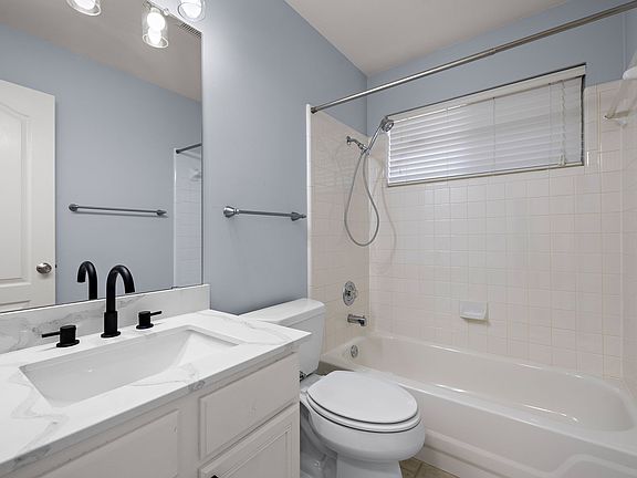 Common bathroom, located between the two bedrooms, was just updated with modern quartz countertops and matte black faucets