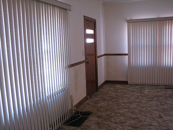 part of open family/living room with 2 large windows