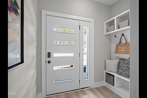 Welcoming foyer with shoe and coat collection space