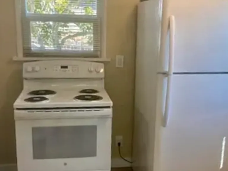 Kitchen with appliances. Alternate placement for refrigerator in kitchen available.