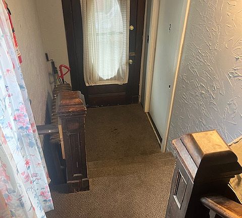 inside the entry door - bottom of the stairs