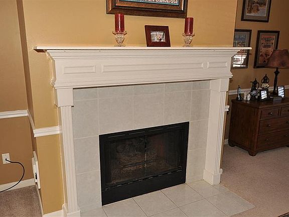 The gas log fireplace makes fires convenient and is surrounded by a custom mantel.