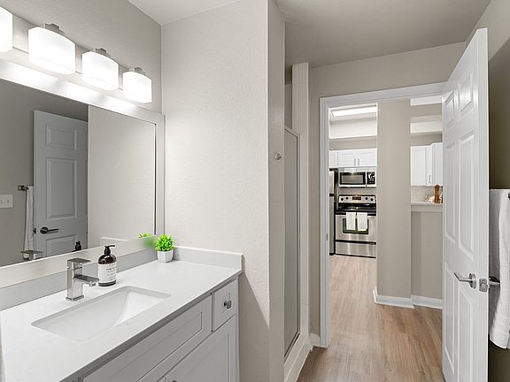 Renovated Bathrooms with New Vanities, Countertops, and Lighting