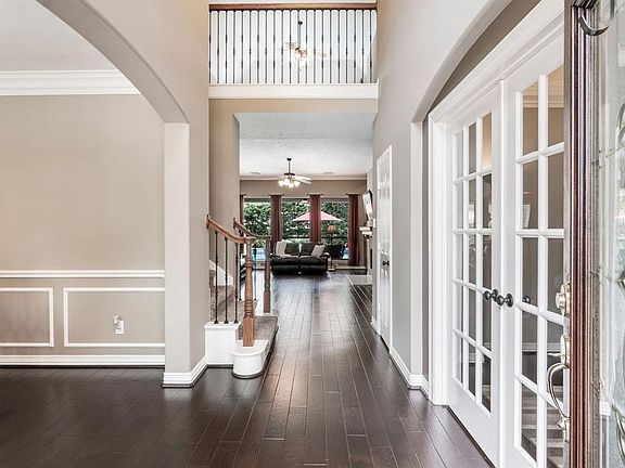 Stunning and Welcoming Two-Story Foyer is the perfect place for greeting family and friends! Note the upgraded  Iron Banister and Eyebrow Archways!