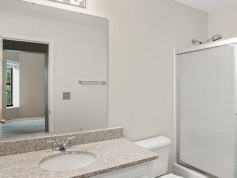 1of 2 full bathrooms; new showerhead, lighting, and mirror