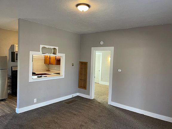 Living room with window to kitchen