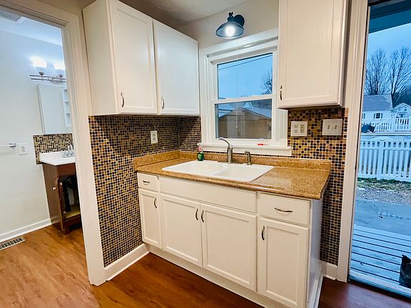 Doorway from kitchen goes to private side porch and private driveway.