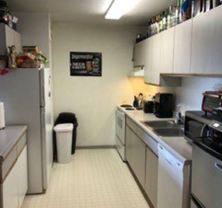 Large kitchen, with stainless steel side by side refrigerator, quiet Bosch dishwasher, electric stove, and lots of counter and cabinet space!