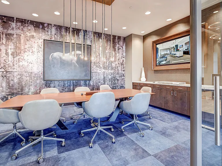 Modern conference room with stunning light fixtures and a TV
