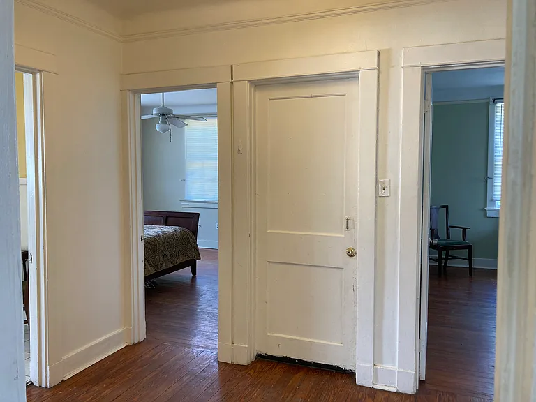 Hallway looking into bedrooms #1 & 2, door to back stairway/entrance