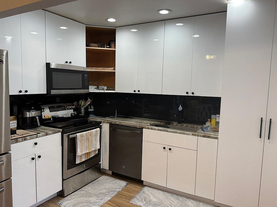 Newly renovated kitchen with European soft-close cabinets and stainless steel appliances